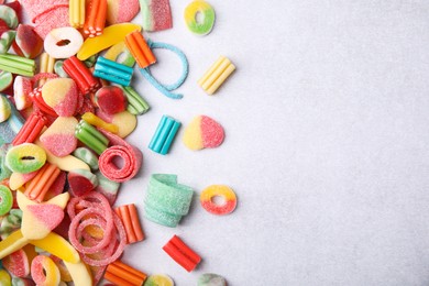 Photo of Many tasty colorful jelly candies on white table, flat lay. Space for text