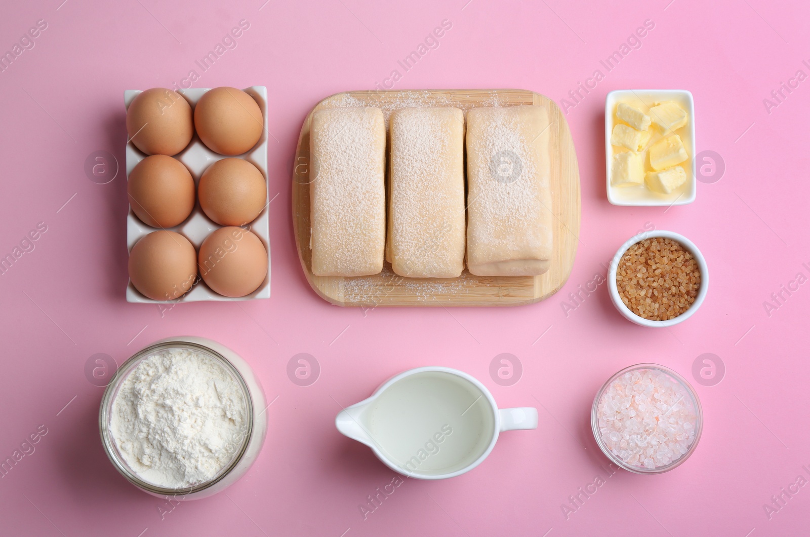 Photo of Flat lay composition of puff pastry dough and ingredients on pink background