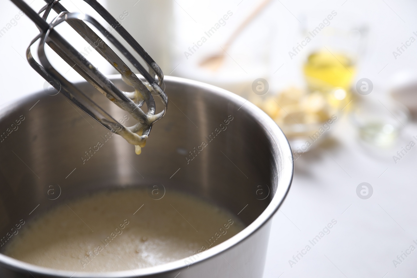 Photo of Making dough in bowl of stand mixer on white table