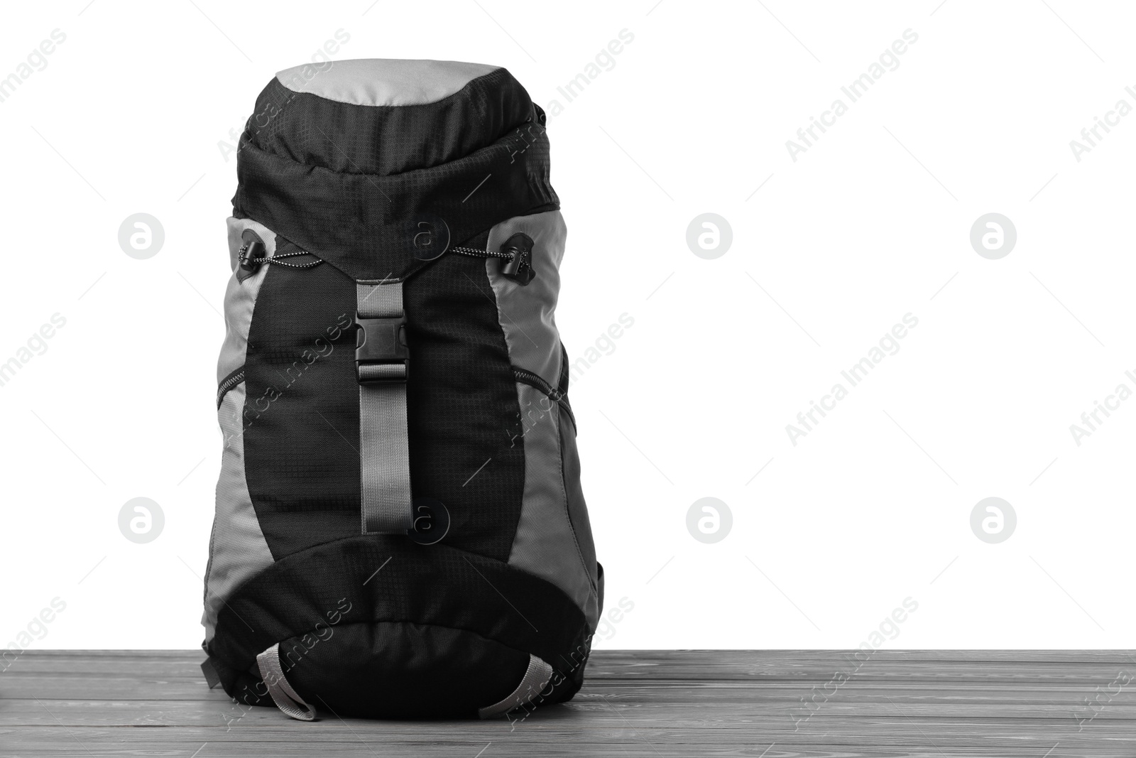 Photo of Hiking backpack on wooden surface against white background. Space for text