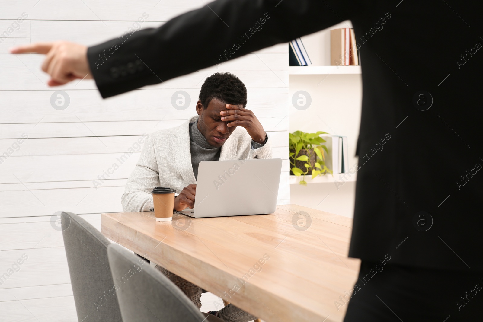 Photo of African American man suffering from racial discrimination at work