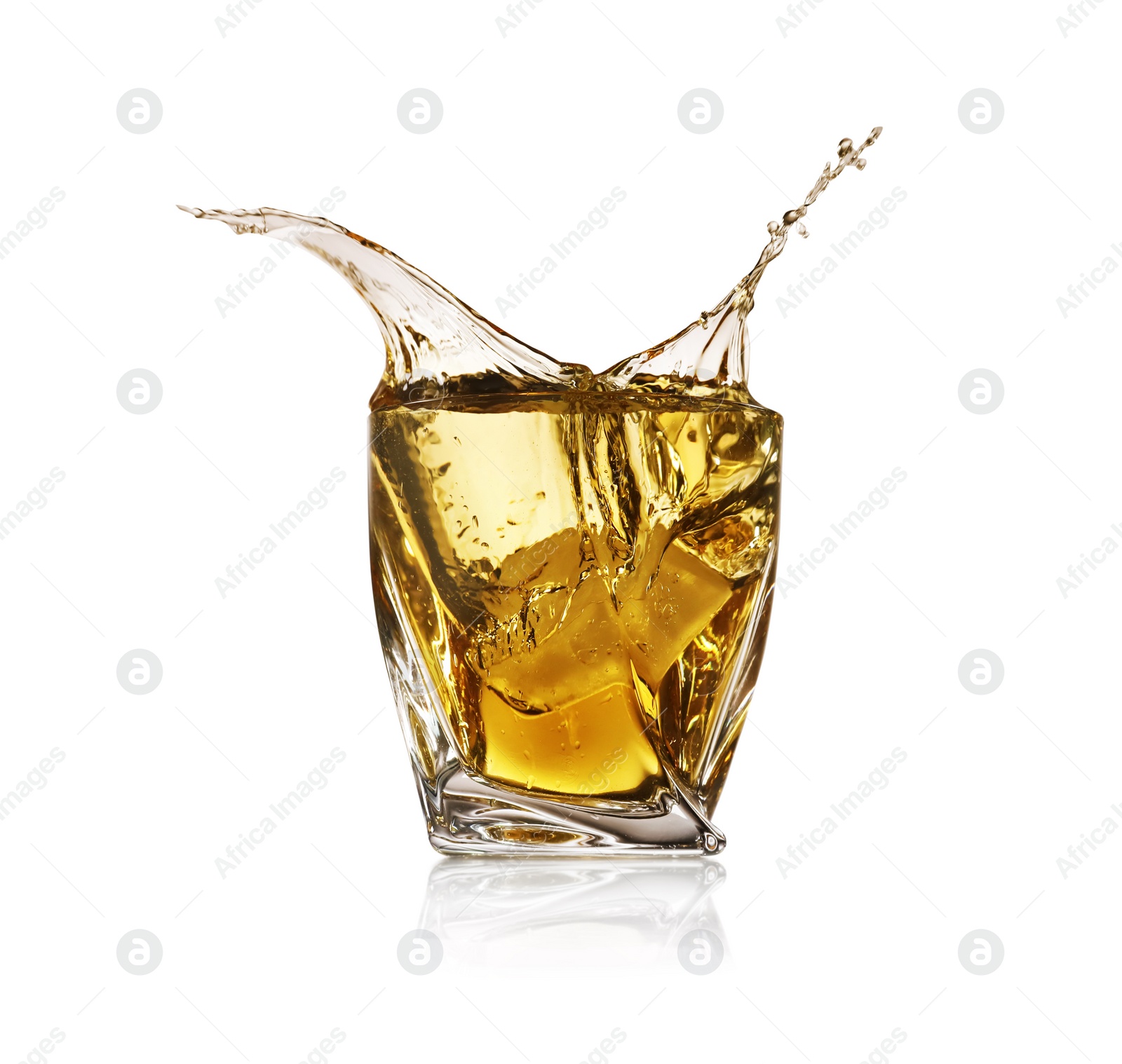 Photo of Whiskey splashing in glass on white background