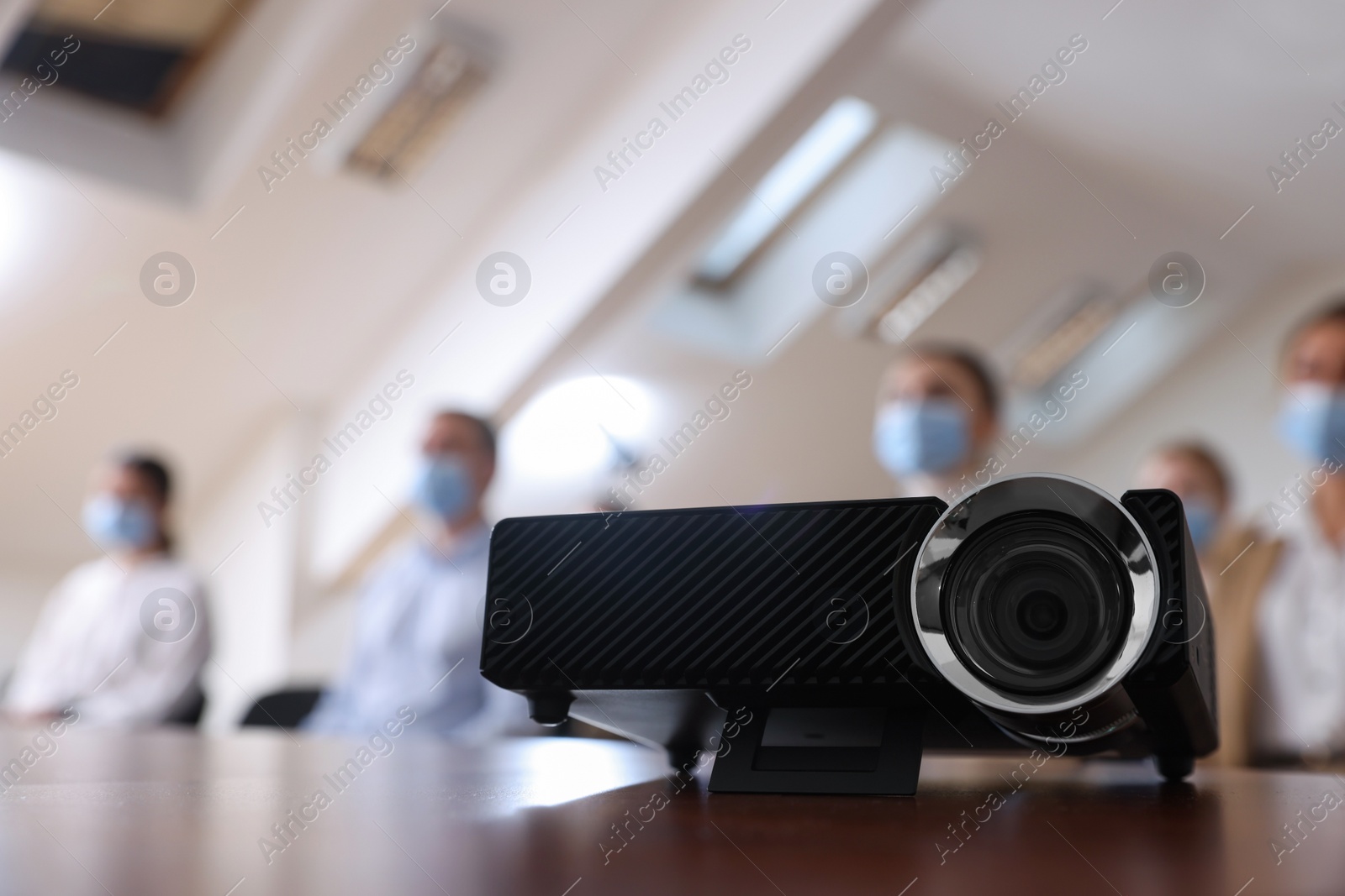 Photo of Modern video projector on table during conference