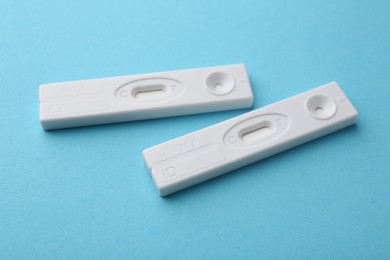 Photo of Disposable express tests on light blue background