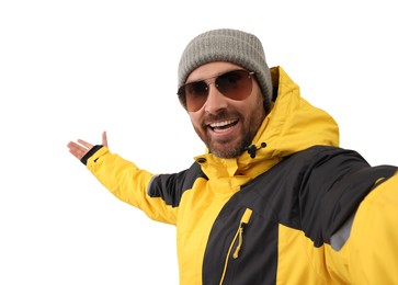 Smiling man in hat and sunglasses taking selfie on white background