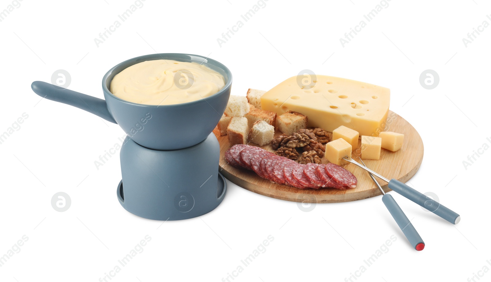 Photo of Fondue with tasty melted cheese, forks and different snacks isolated on white