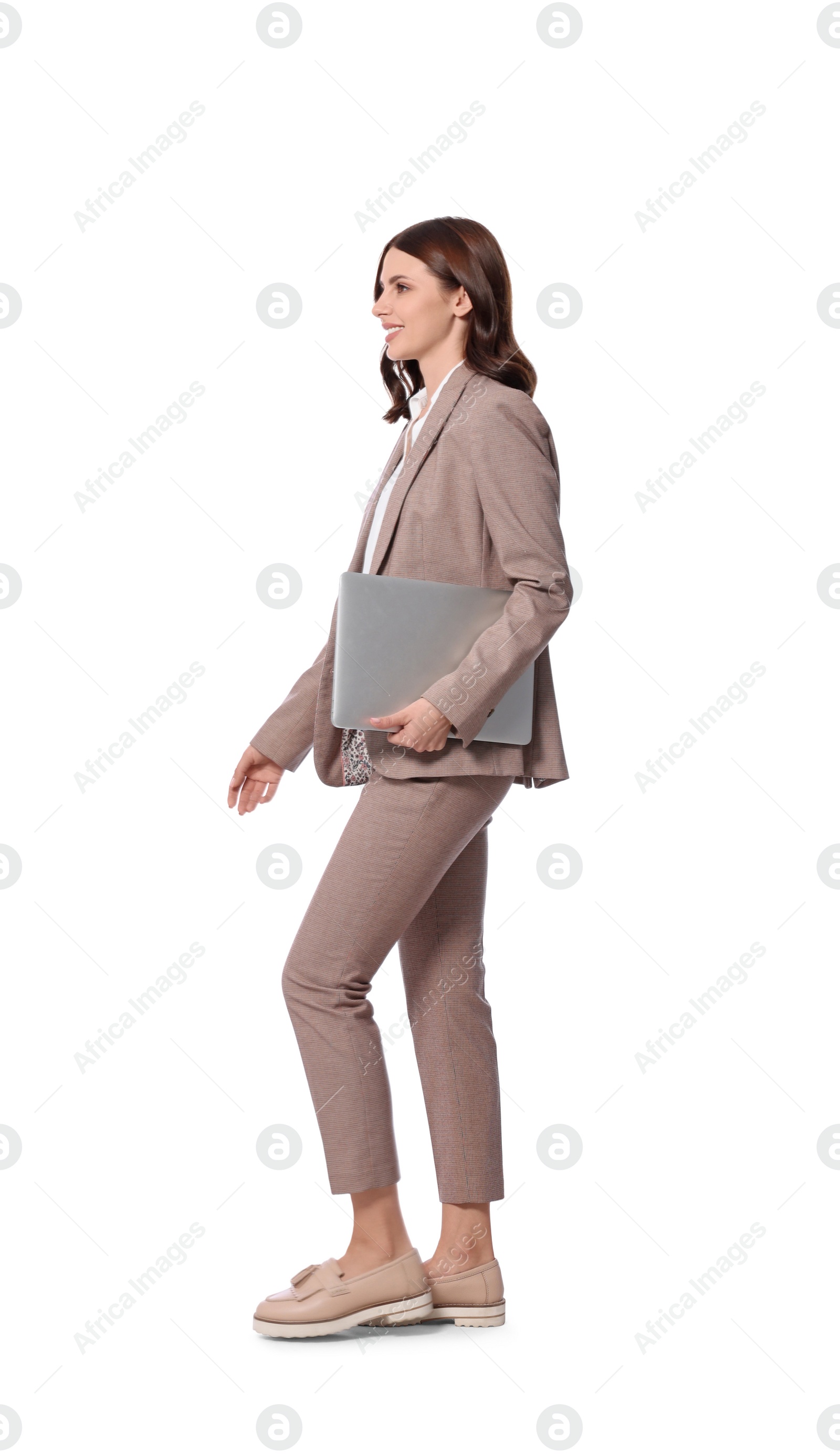 Photo of Happy young businesswoman with laptop walking on white background