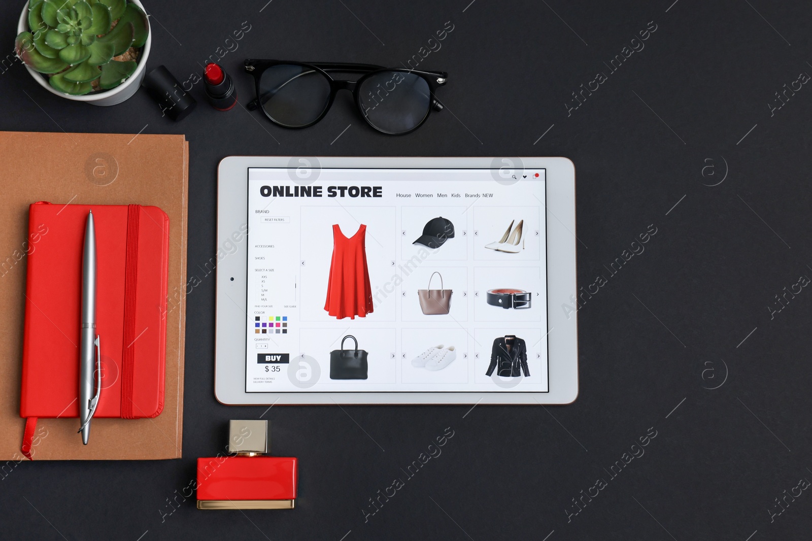 Photo of Online shopping. Flat lay composition with modern tablet on black background