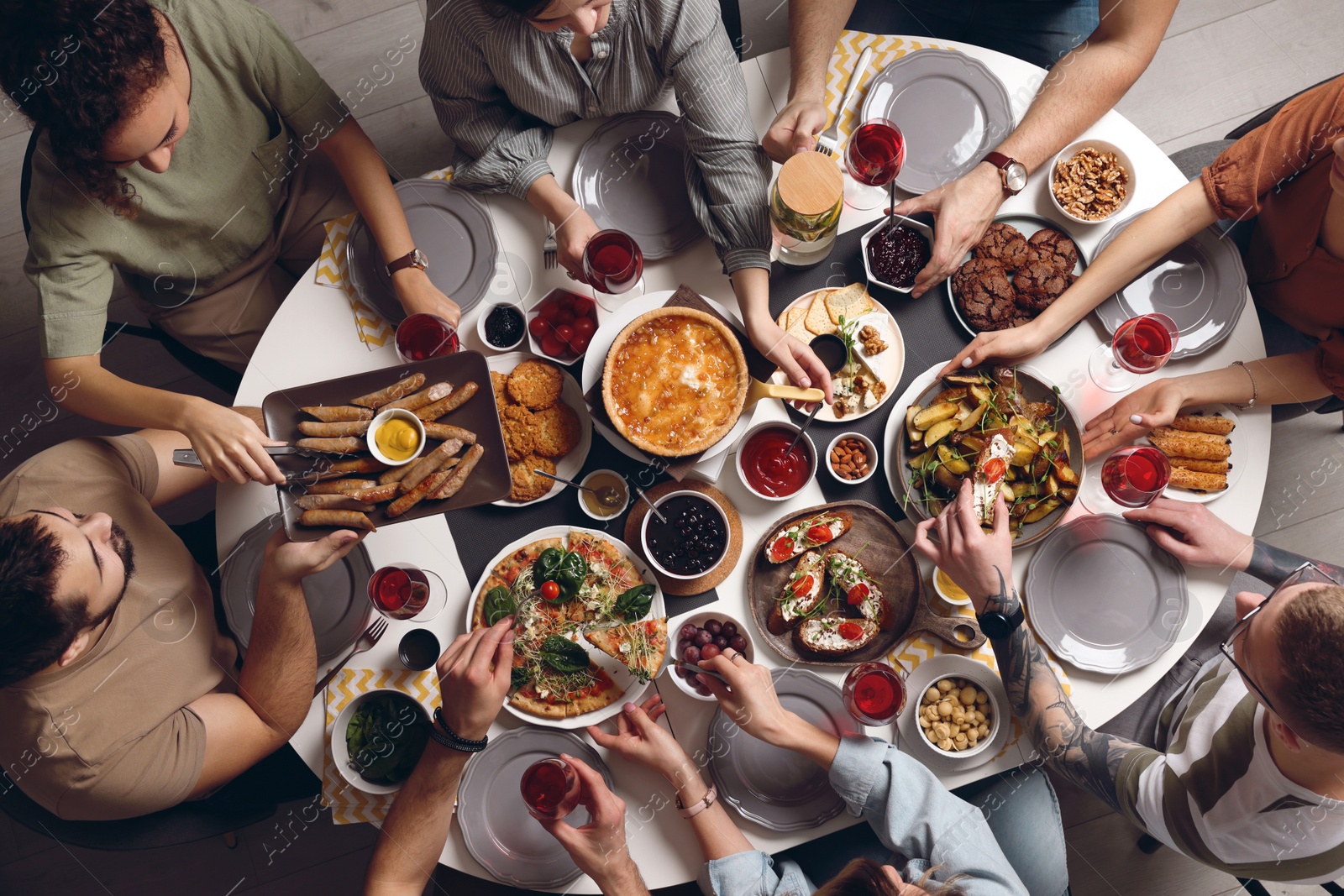 Photo of Group of people having brunch together at table indoors, top view