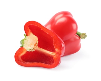 Whole and cut red bell peppers on white background