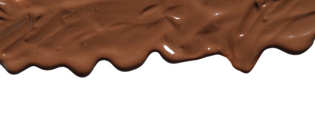 Photo of Tasty melted milk chocolate pouring down on white background