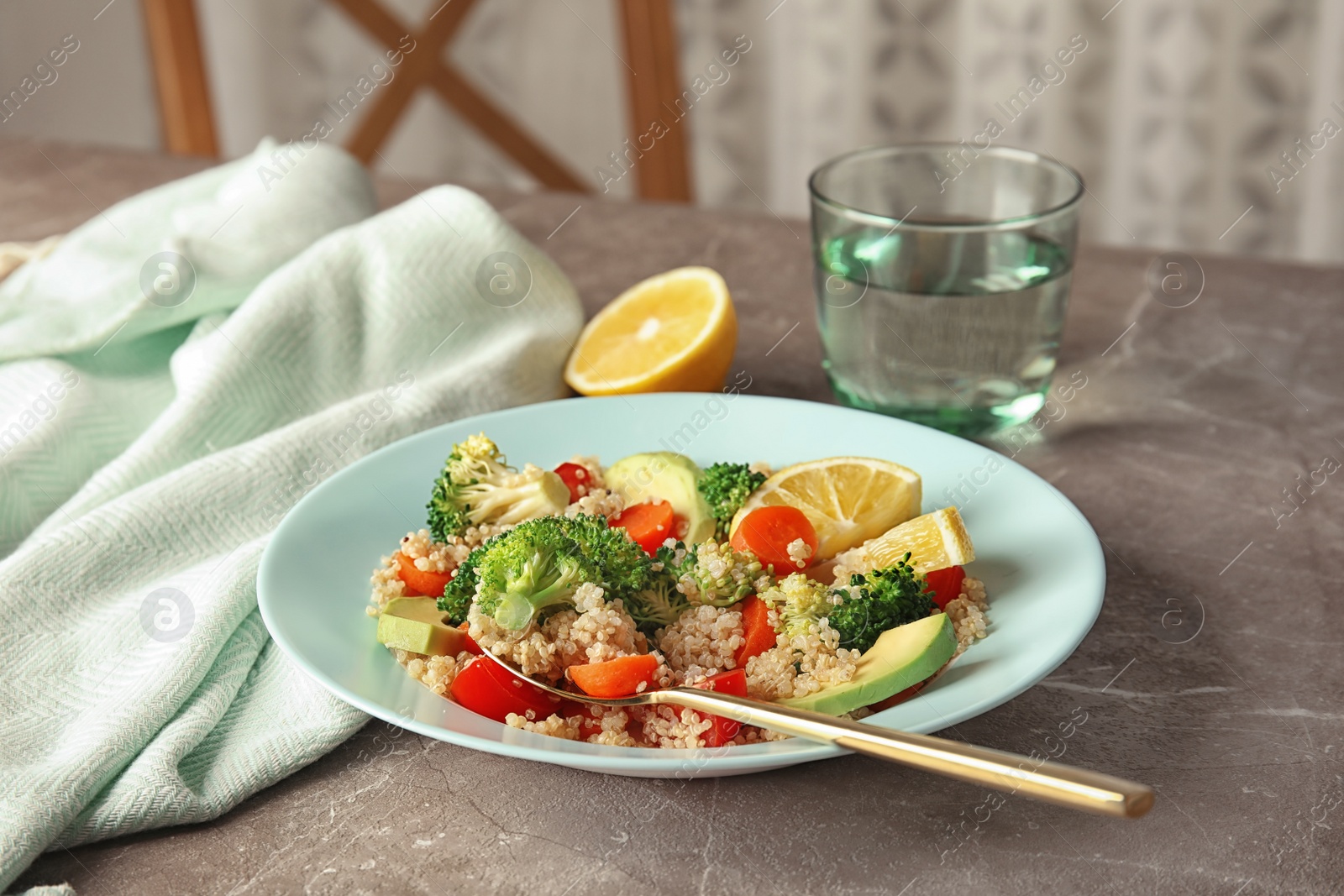 Photo of Salad with quinoa in plate on table