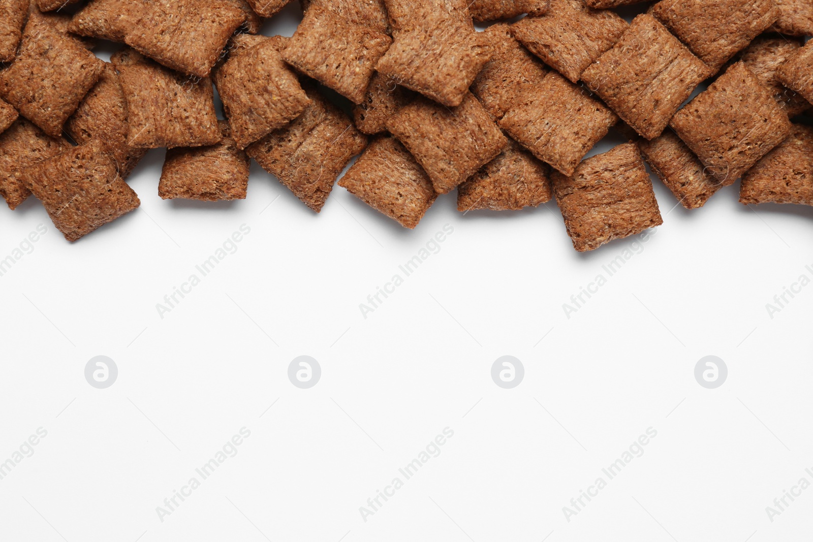 Photo of Sweet crispy chocolate corn pads on white background, top view. Space for text