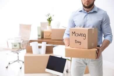 Photo of Man holding moving boxes in new office, closeup. Space for text