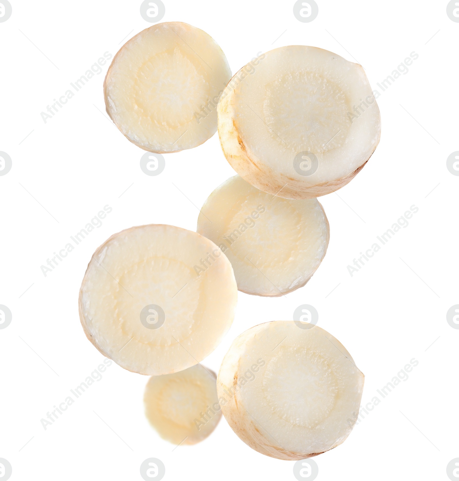 Image of Slices of fresh parsley root falling on white background