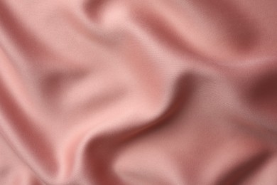 Photo of Texture of pink silk fabric as background, top view