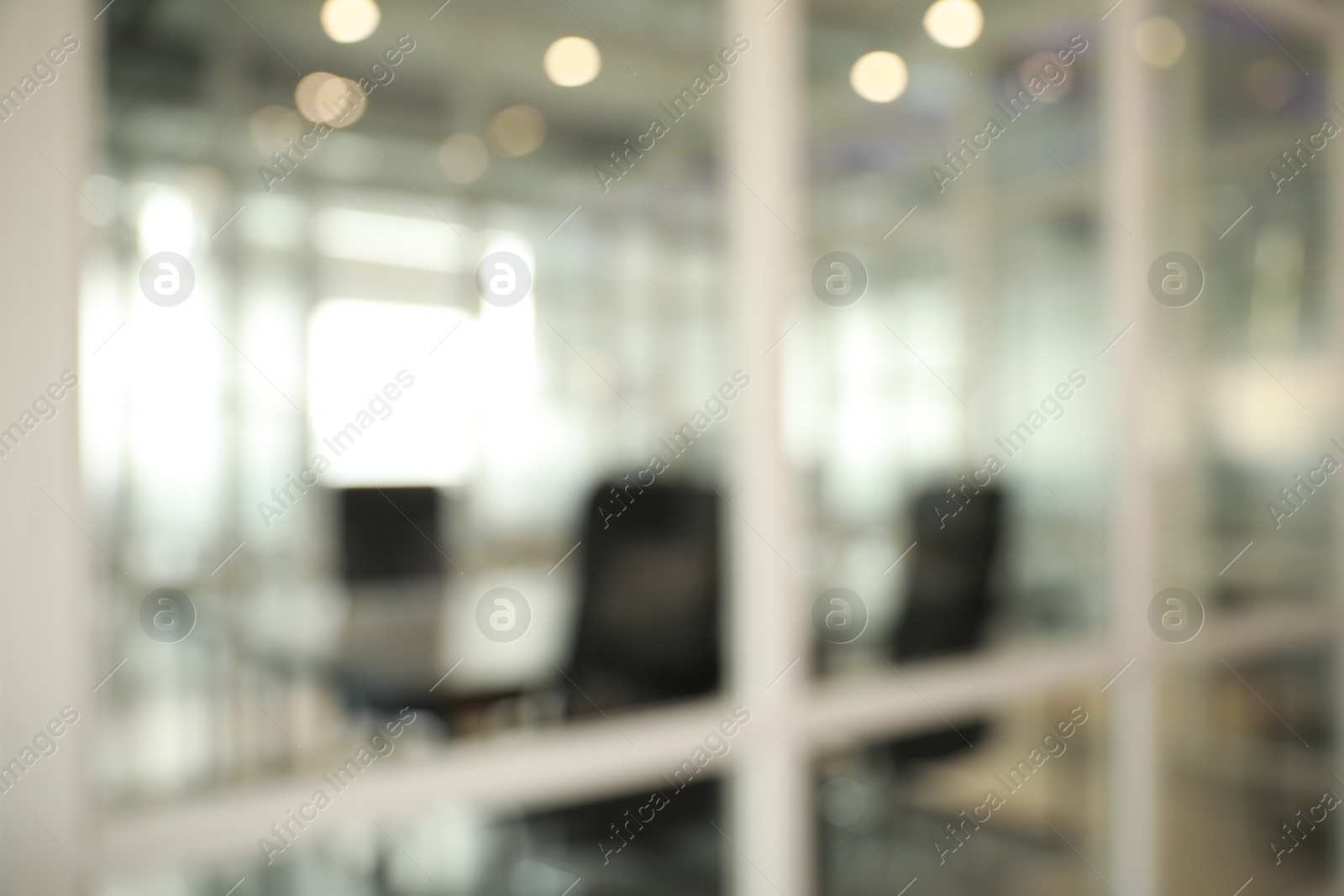 Photo of Blurred view of cozy workspaces with tables and chairs in office