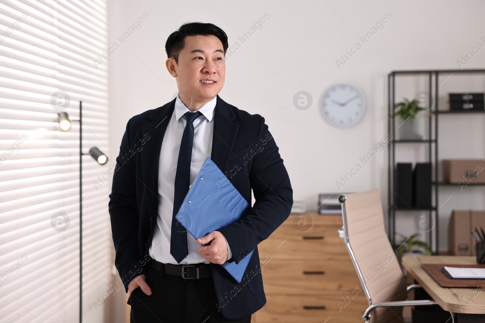 Photo of Portrait of happy notary with clipboard in office, space for text