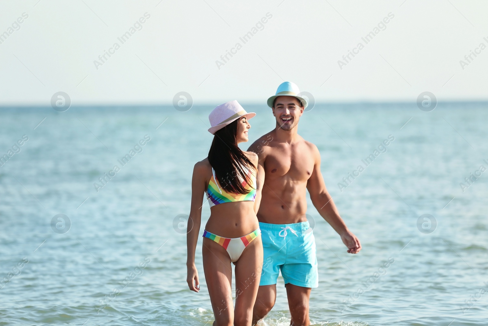 Photo of Happy young couple having fun at beach on sunny day