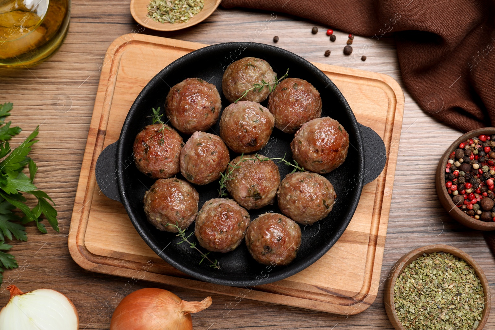 Photo of Tasty cooked meatballs on wooden table, flat lay