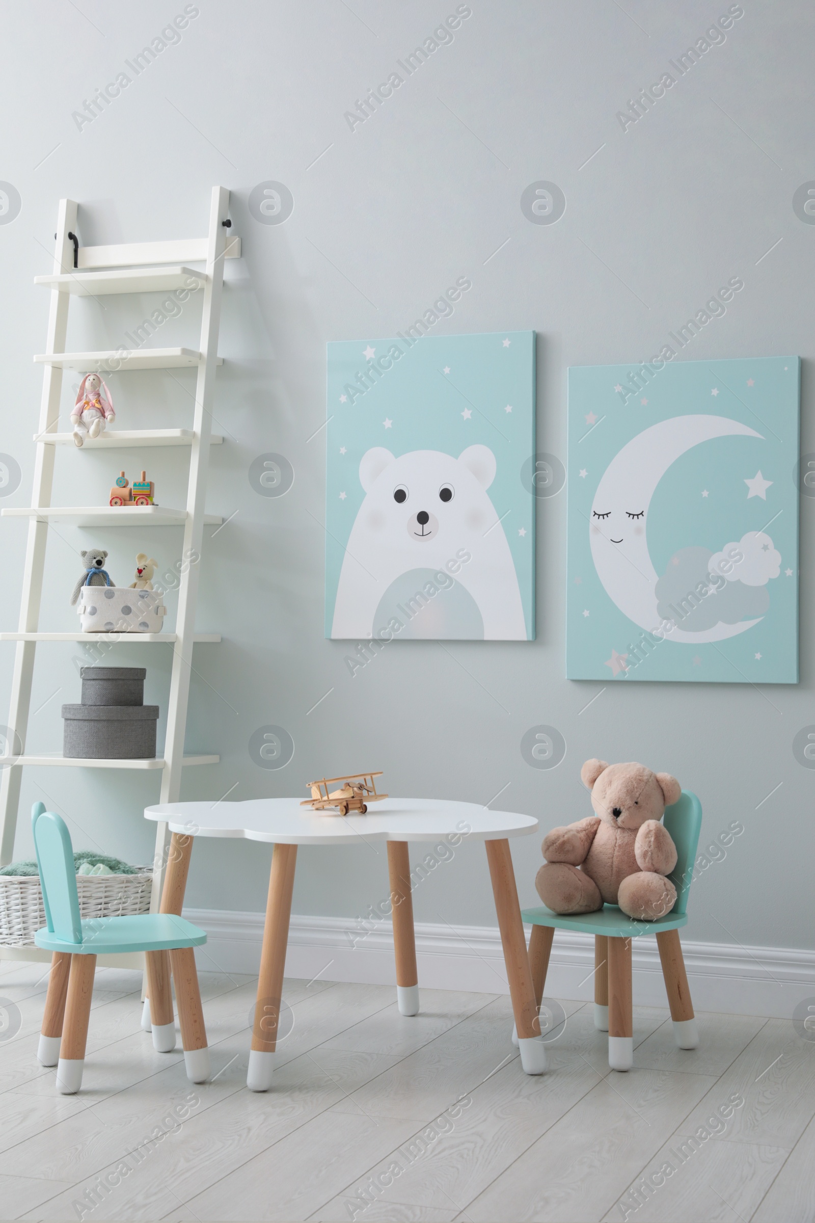 Photo of Children's room interior with table and cute pictures on wall