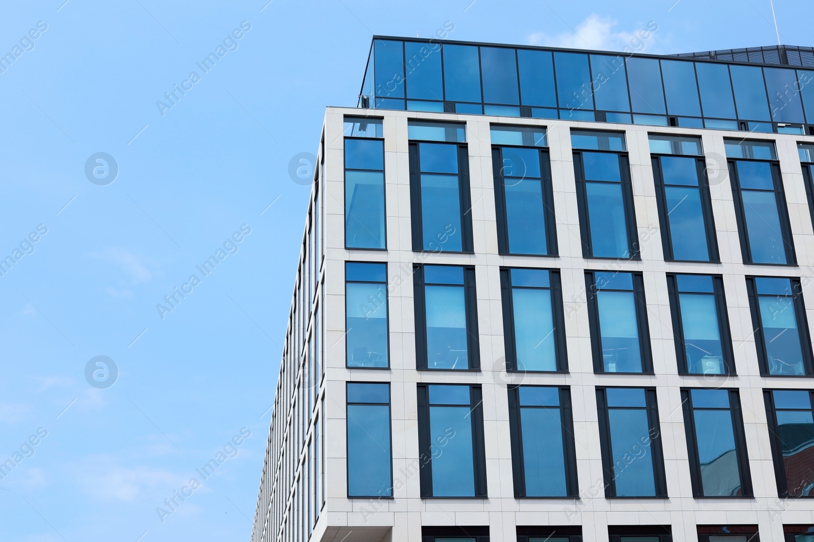 Photo of Building with tinted windows, outdoors. Modern architectural design