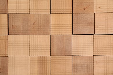 Photo of Set of wooden cubes as background, top view. Montessori toy