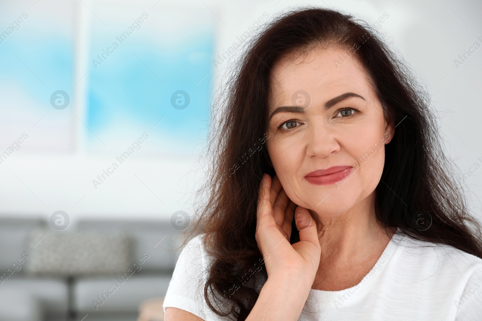 Photo of Portrait of mature woman with beautiful face indoors. Space for text