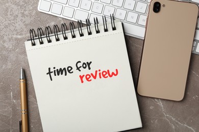Image of Notepad with text Time For Review, pen, computer keyboard and mobile phone on grey table, flat lay