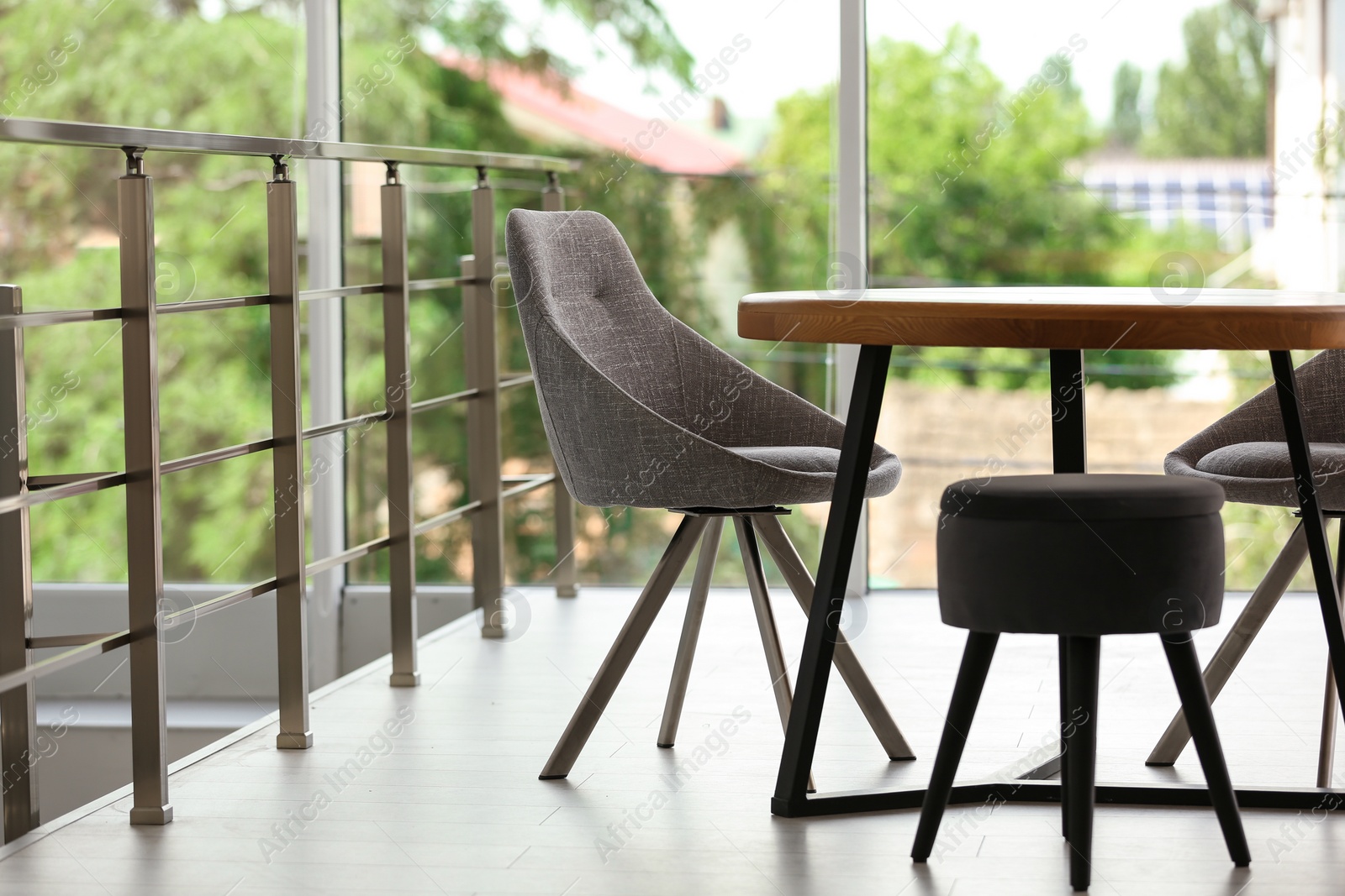 Photo of Stylish room interior with round table and comfortable chairs