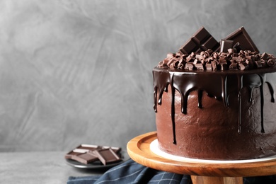 Freshly made delicious chocolate cake on grey background