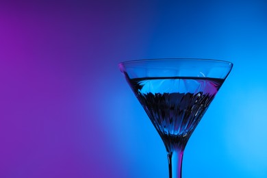 Photo of Fresh martini in neon lights, space for text