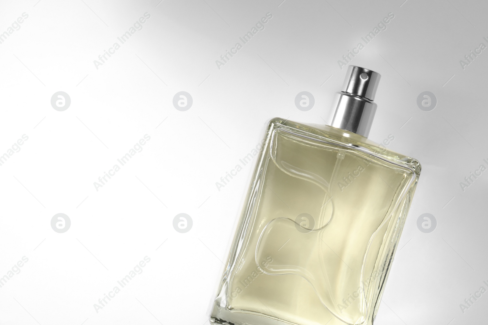 Photo of Luxury men`s perfume in bottle on white background, top view. Space for text