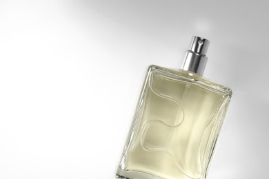 Photo of Luxury men`s perfume in bottle on white background, top view. Space for text