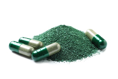 Photo of Pile of spirulina powder and pills on white background