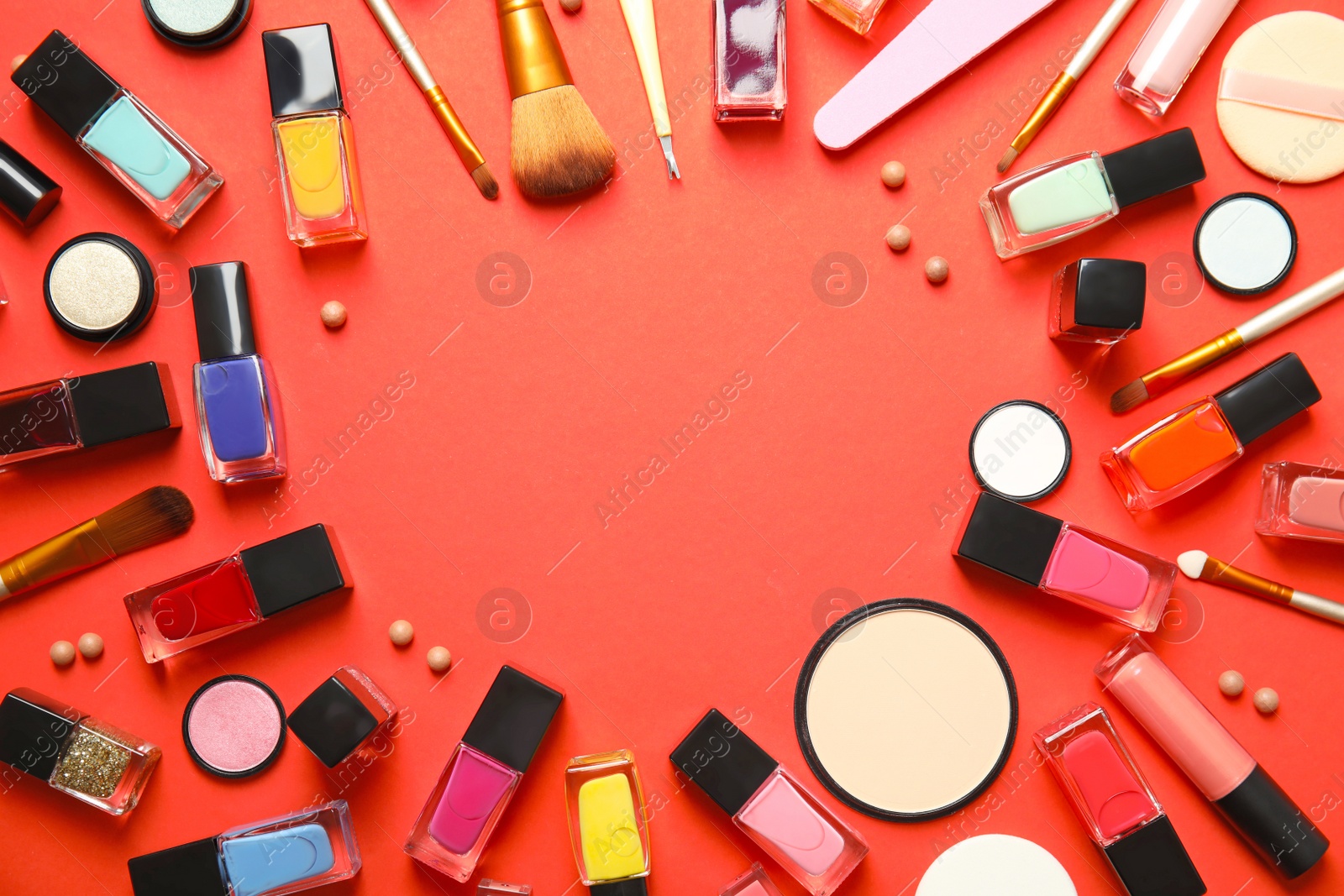 Photo of Flat lay composition with cosmetics, bottles of nail polish and space for text on color background