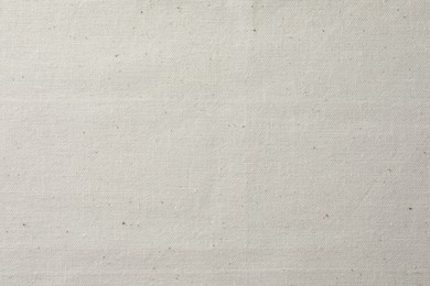 Photo of Texture of beige fabric as background, top view