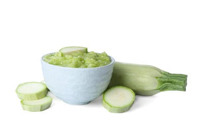 Photo of Delicious vegetable puree and fresh zucchini on white background. Healthy food