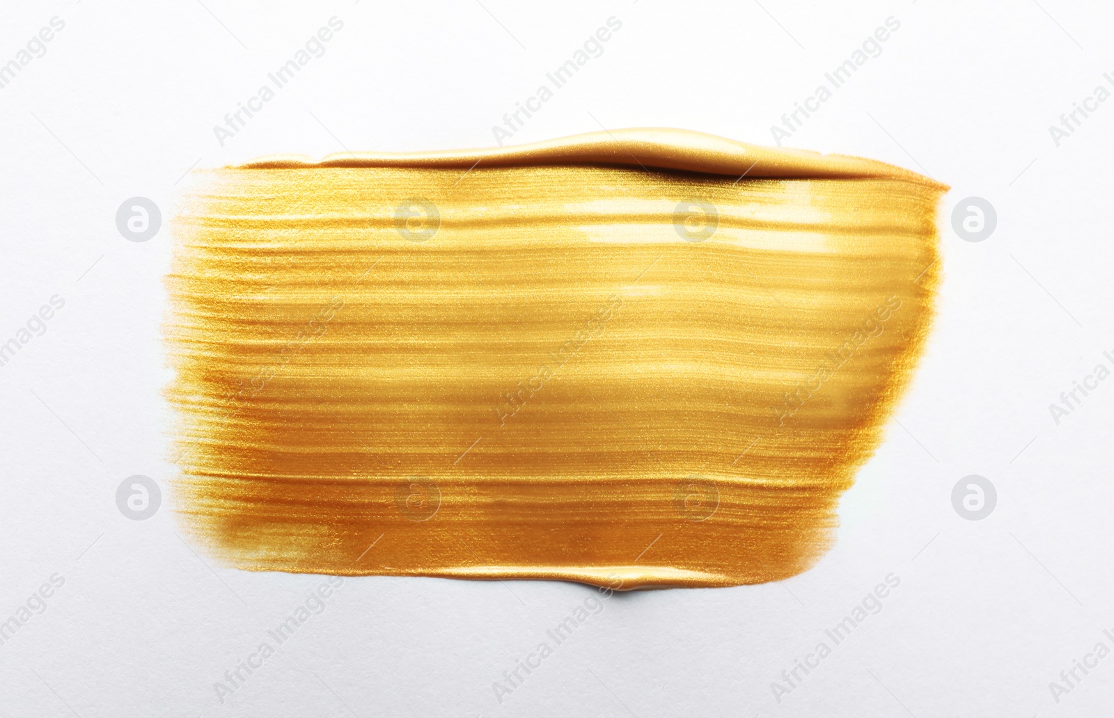 Photo of Stroke of gold paint isolated on white, top view