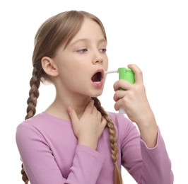 Photo of Little girl using throat spray on white background