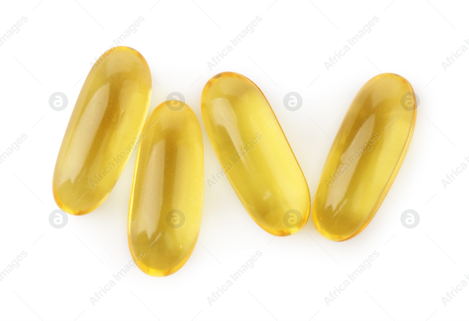 Photo of Many yellow vitamin capsules isolated on white, top view