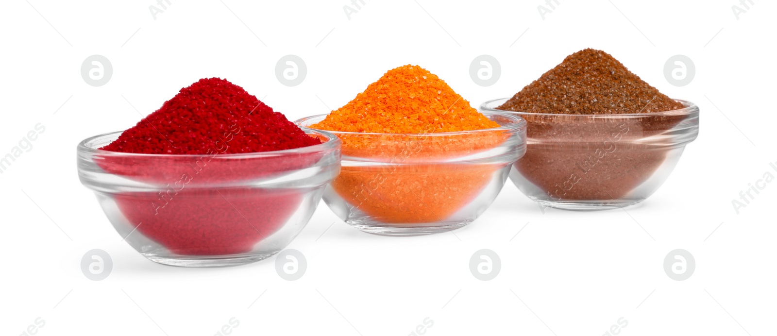 Photo of Glass bowls with different food coloring isolated on white