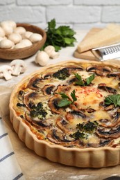 Photo of Delicious quiche with mushrooms and parsley on table, closeup