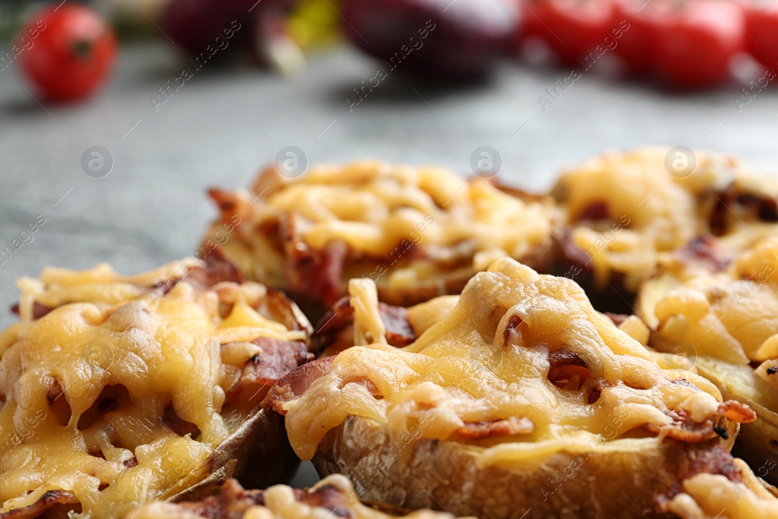 Photo of Baked potatoes with cheese and bacon on table, closeup