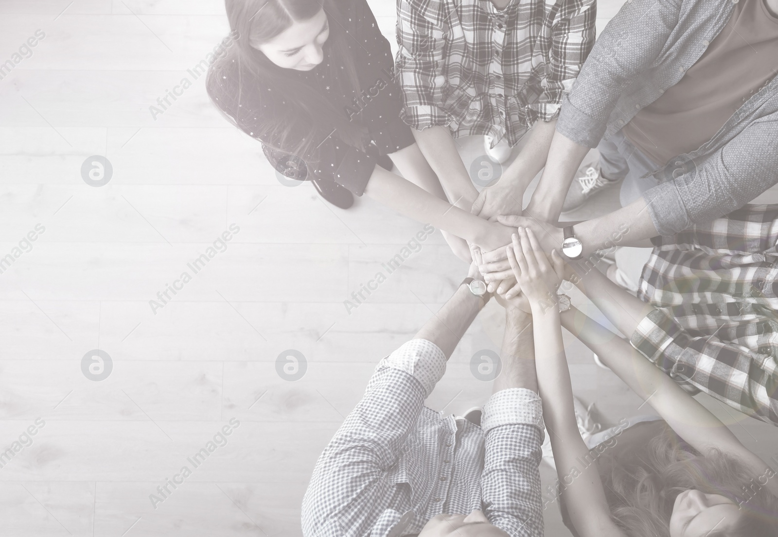 Image of People putting hands together, top view. Unity concept