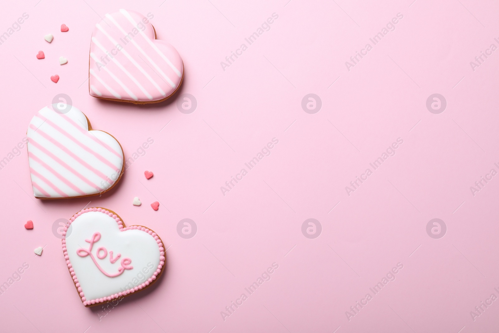 Photo of Heart shaped cookies on pink background, flat lay with space for text. Valentine's day treat