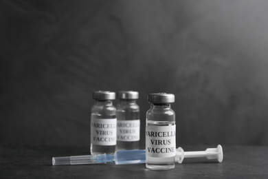 Photo of Chickenpox vaccine and syringe on grey background. Varicella virus prevention