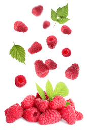 Image of Fresh ripe raspberries with green leaves falling on white background