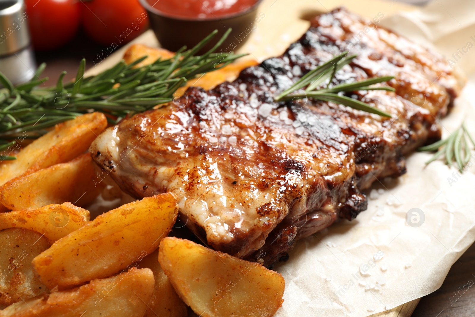 Photo of Delicious grilled ribs and garnish, closeup view