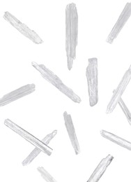 Image of Translucent menthol crystals falling on white background